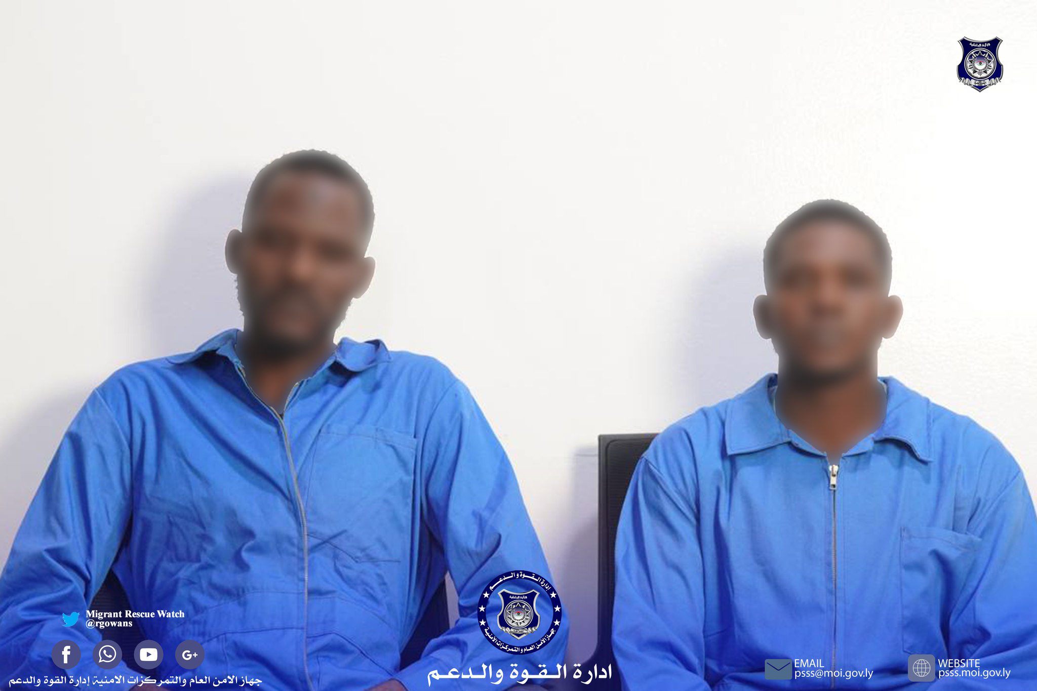 Two Nigerian suspects in handcuffs being escorted by Tripoli police officers after their arrest for alleged involvement in multiple store robberies.