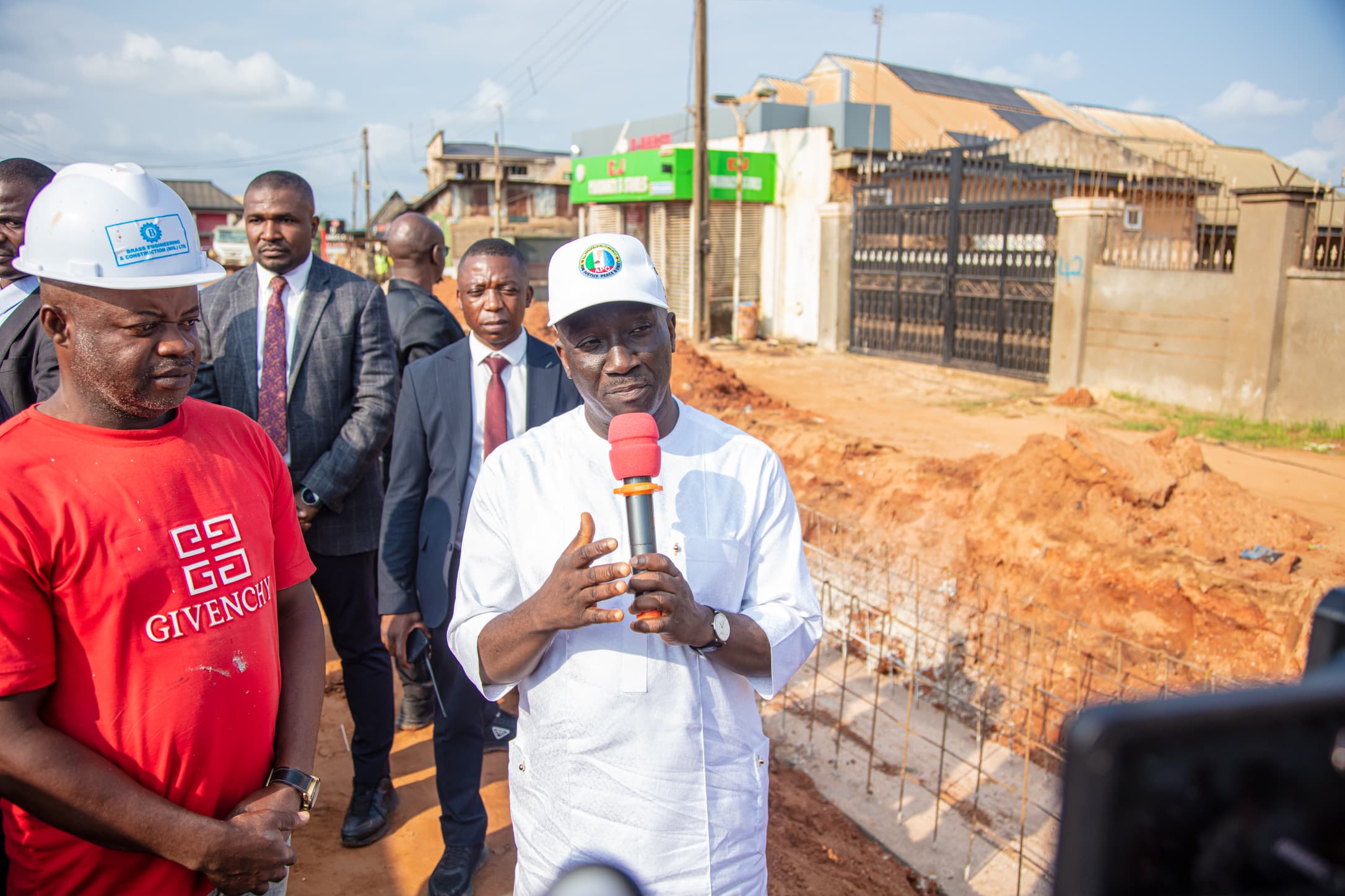 overnor Monday Okpebholo walking through Sapele Road in Benin City during an inspection of ongoing road construction projects, engaging with residents and inspecting drainage and road quality