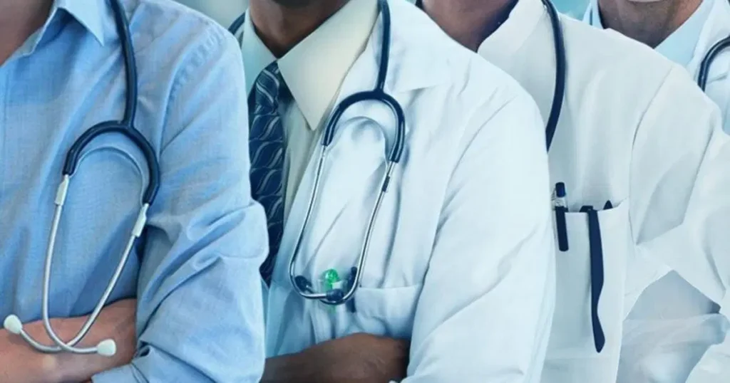 Group of doctors protesting in lab coats holding placards during a nationwide strike in Nigeria.