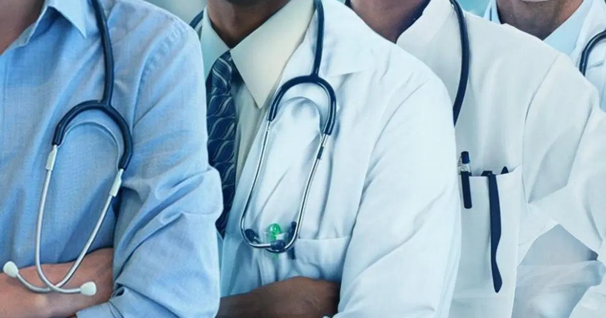 Group of doctors protesting in lab coats holding placards during a nationwide strike in Nigeria.