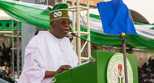 President Bola Ahmed Tinubu delivering Nigeria’s 65th Independence Day speech, standing at a podium with the Nigerian flag in the background.